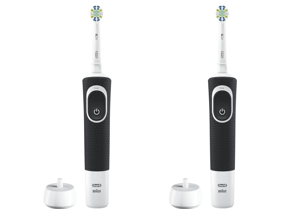 two black and white electric toothbrushes with their chargers