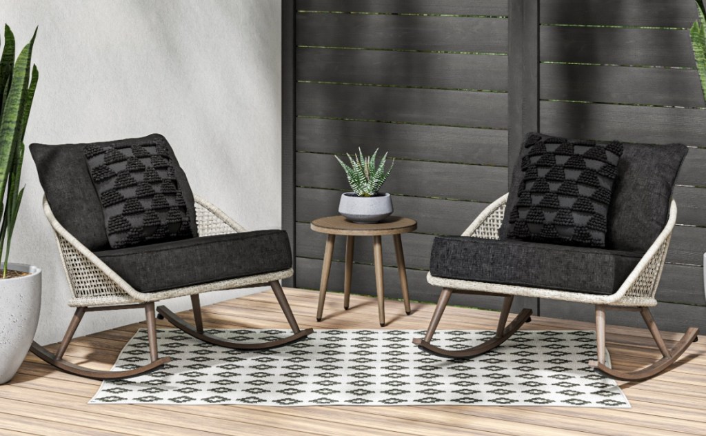 Two rocking patio chairs with charcoal cushions