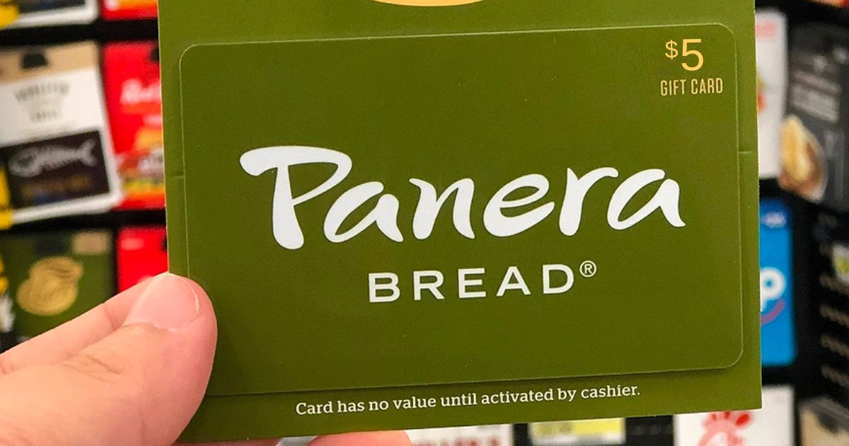 a man's hand holding a Panera 5 dollar giftcard