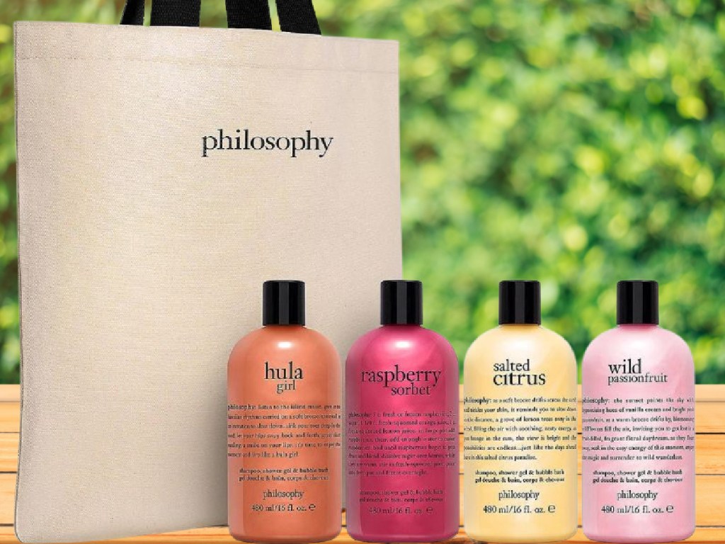 4 bottles of Philosophy Shower Gel next to a canvas tote bag