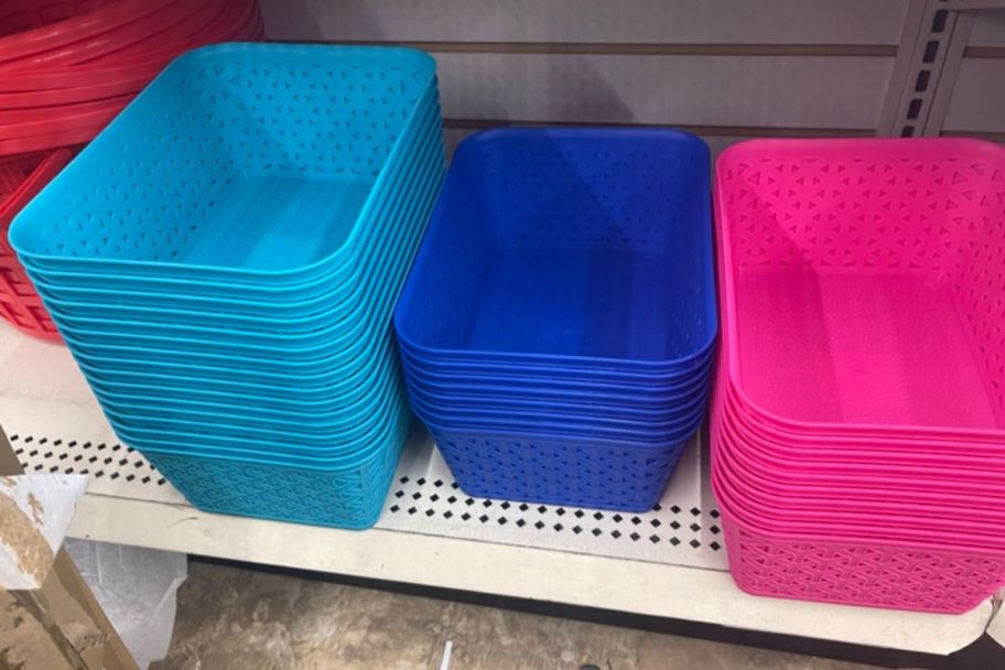 3 stacks of rectangular Plastic storage baskets on a store shelf