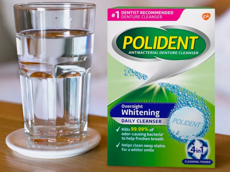 box of polident next to glass of water