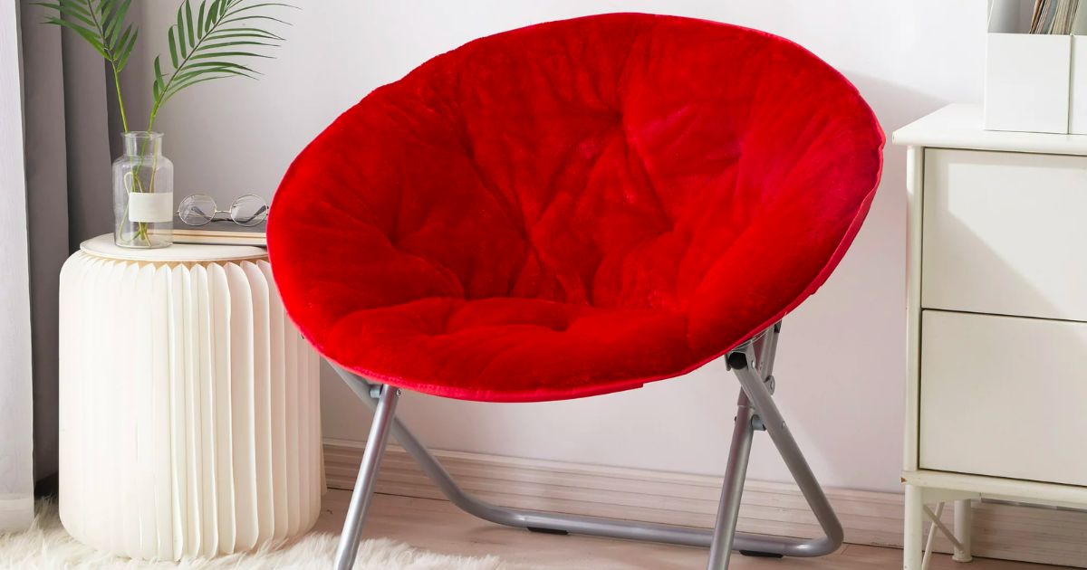 Mainstays red faux fur saucer chair in a room next to a side table