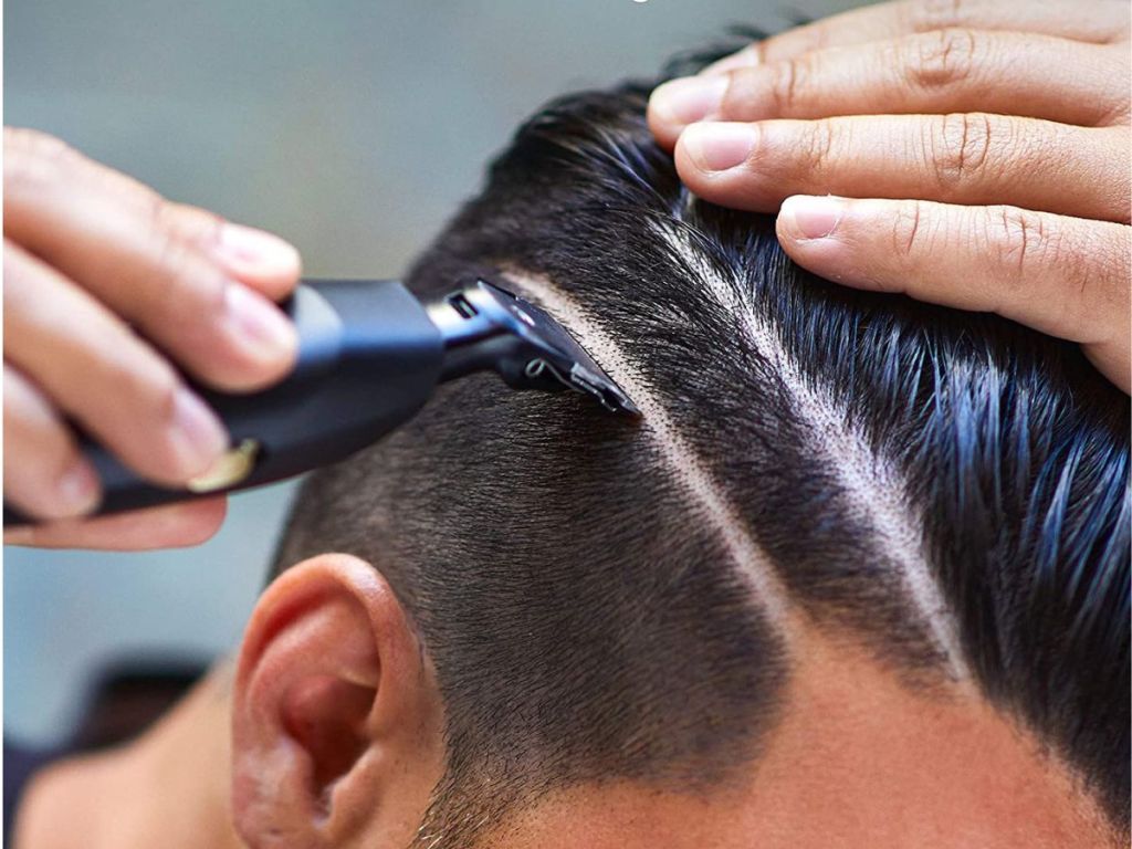man using trimmer on hair