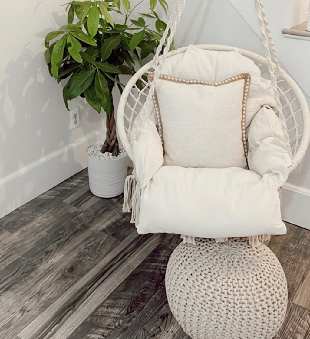 white chair with fluffy cushions hanging from foyer ceiling