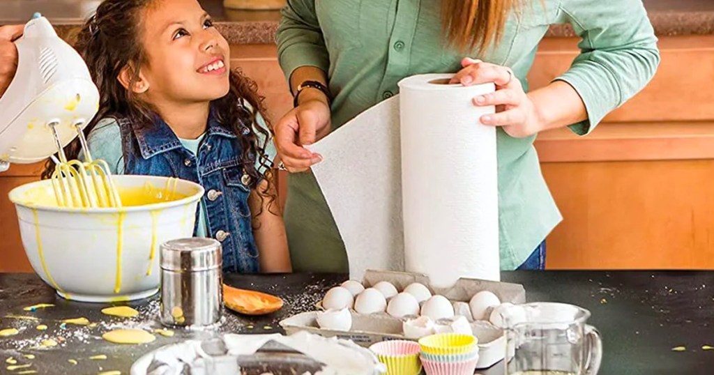 Woman using Scott Choose-A-Sheet Paper Towels in a kitchen with children