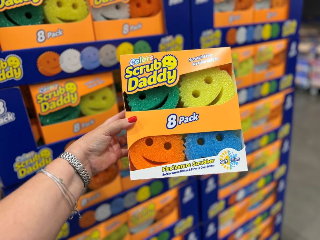Hand holding a pack of Scrub Daddy sponges