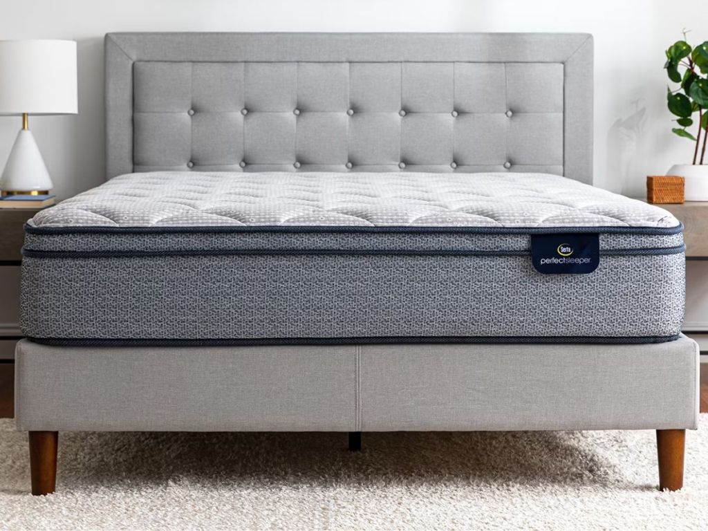 A Sealy Perfect Sleeper Mattress on an upholstered bed frame