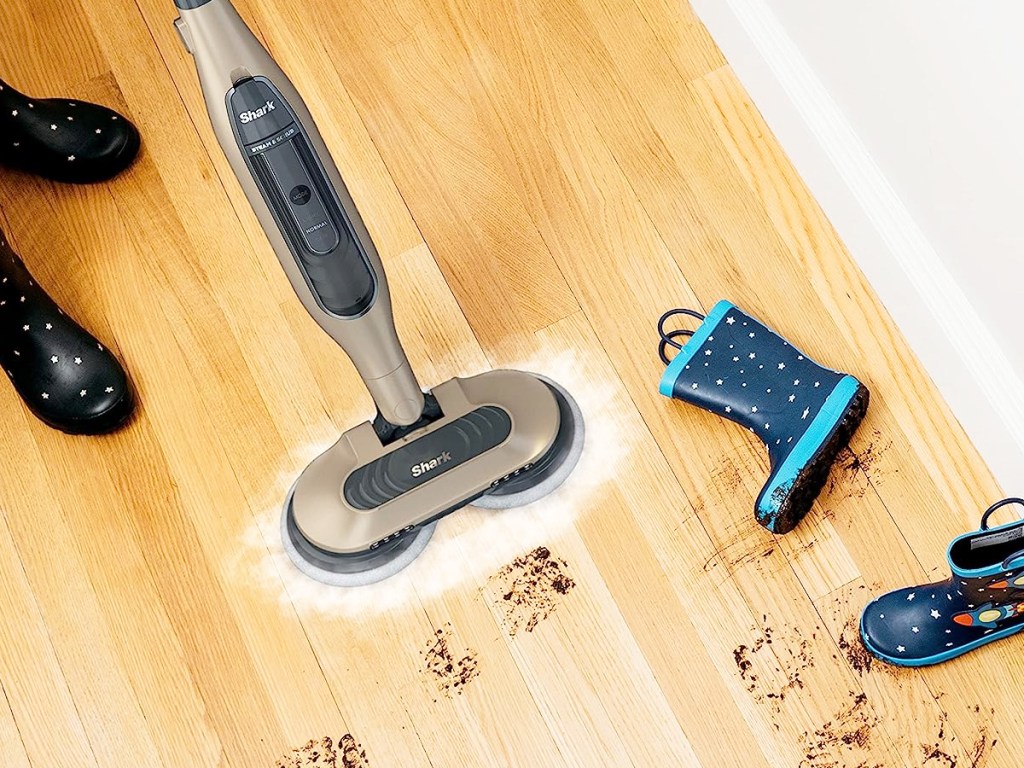 Shark Steam & Scrub Mop on wood floor cleaning up muddy foot prints