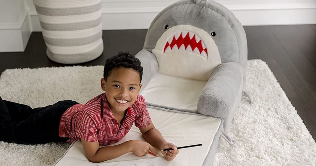 child laying on a Soft Landings Shark chair bed