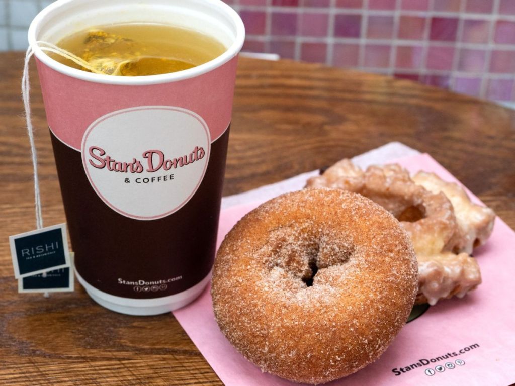 A tea and two donuts on a napkin from Stan's Donuts and Coffee