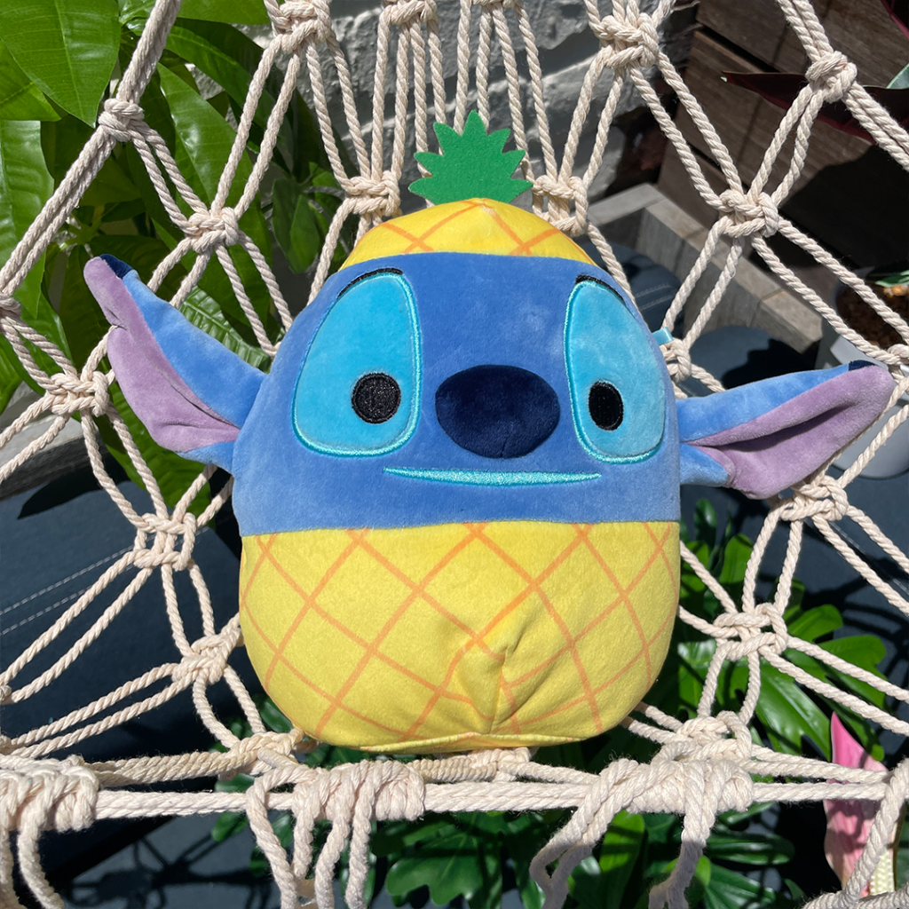 Squishmallows stitch in a pineapple costume sitting in a hammock