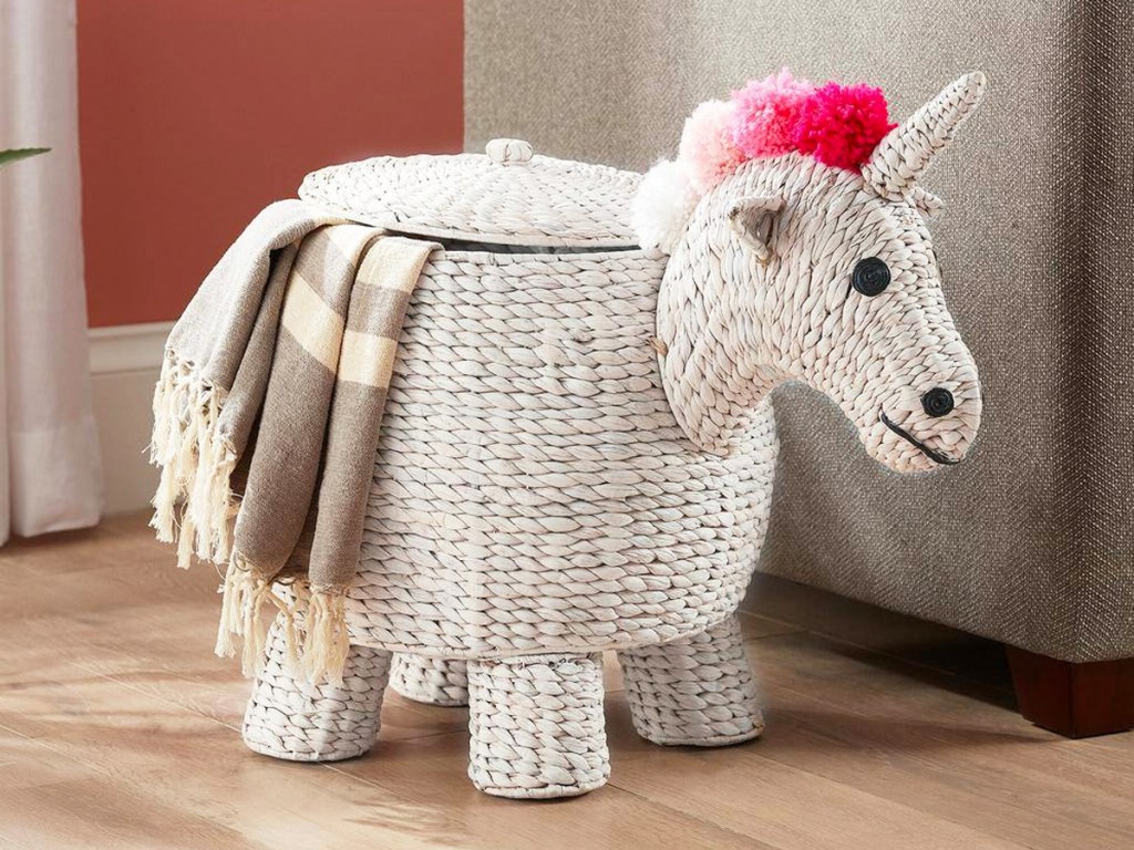 white unicorn storage basket with pink hair and blanket coming out from lid
