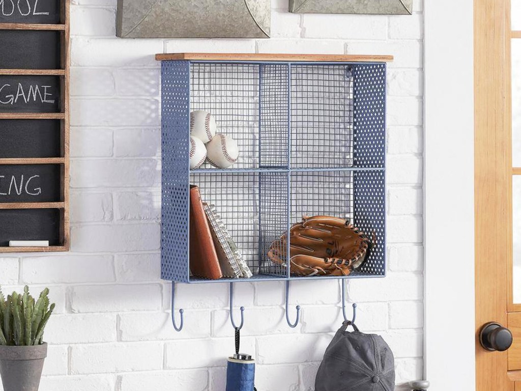 blue metal wall organizer with cubbies and hooks at the bottom