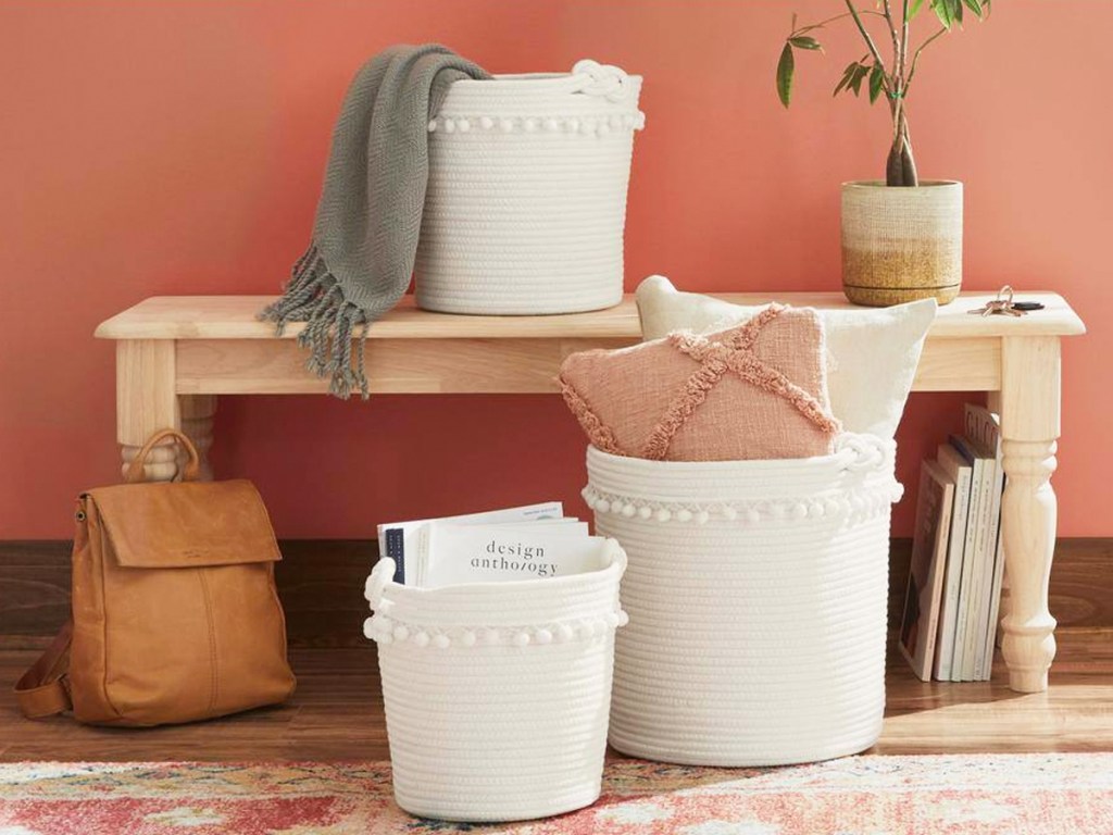matching set of white storage baskets with pompom details