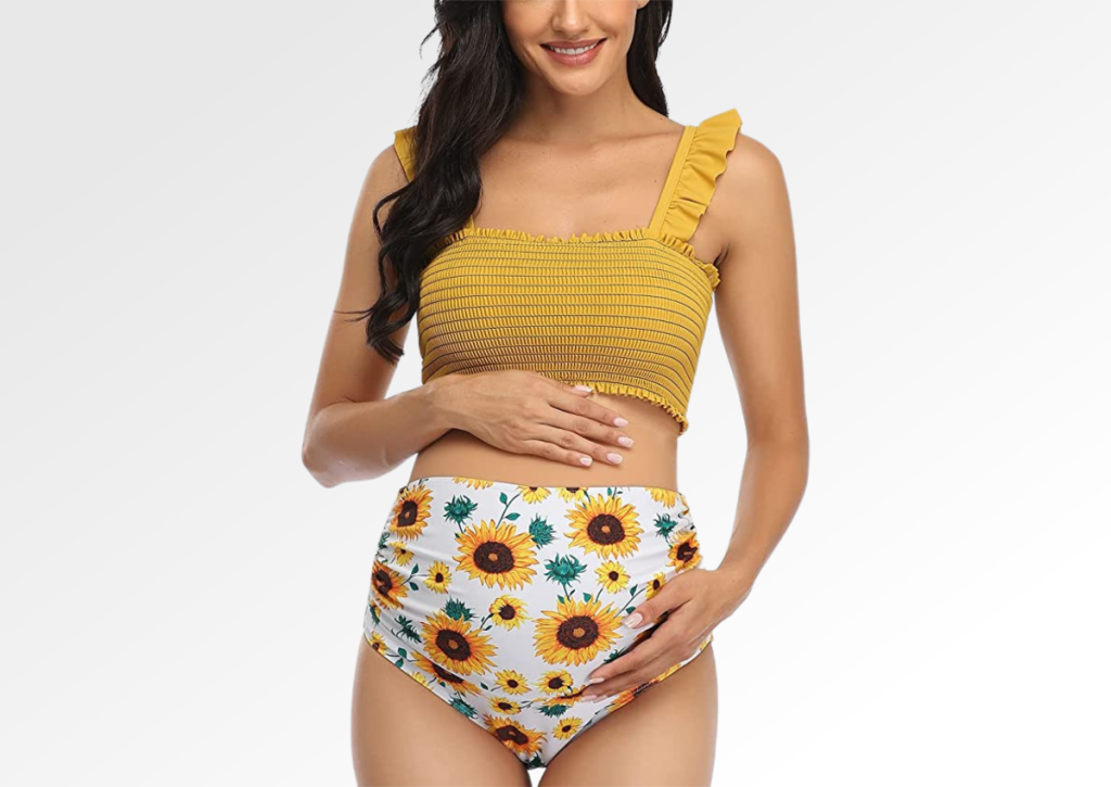 Woman wearing a Summer Mae maternity bikini swimsuit with sunflowers on it