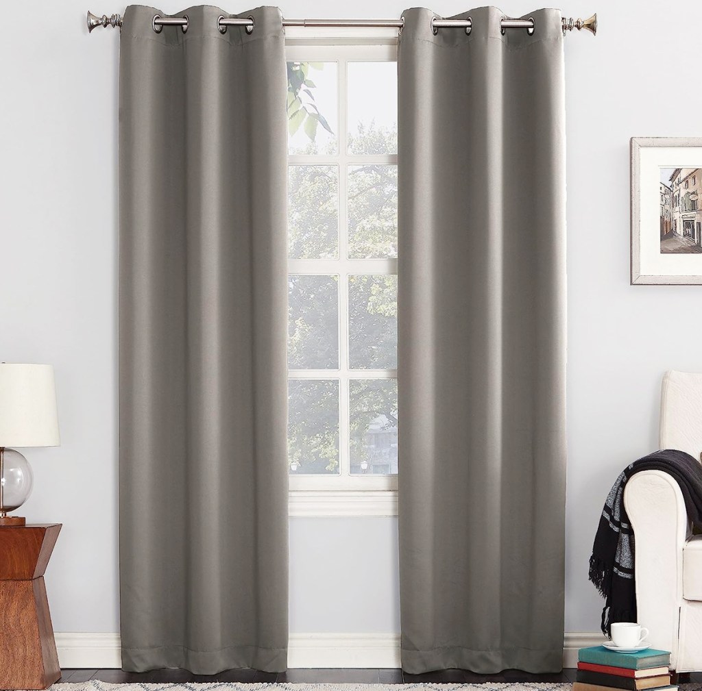 grey curtain panels in front of window
