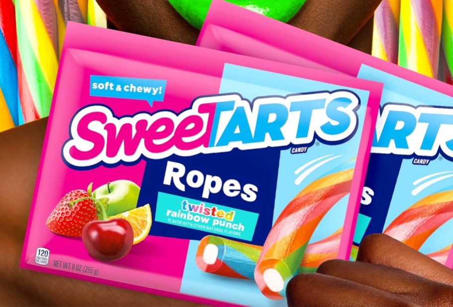 woman holding bags of SweeTARTS Twisted Rainbow Punch Ropes