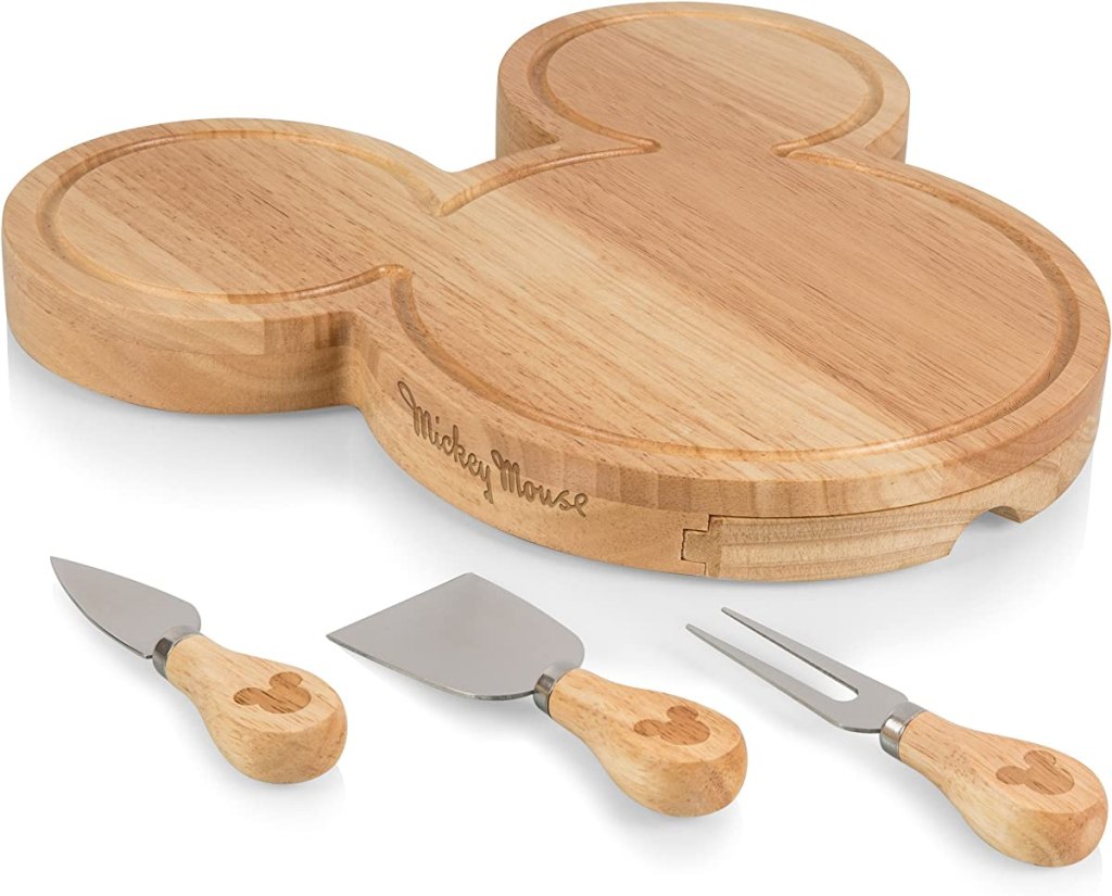 Mickey Mouse head shaped cheeseboard with serving utensils next to it