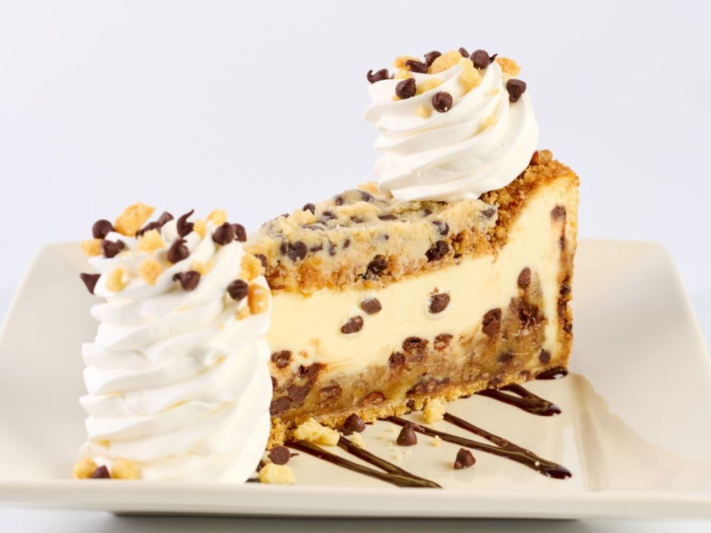 A slice of Cookie Dough Cheesecake with pecans