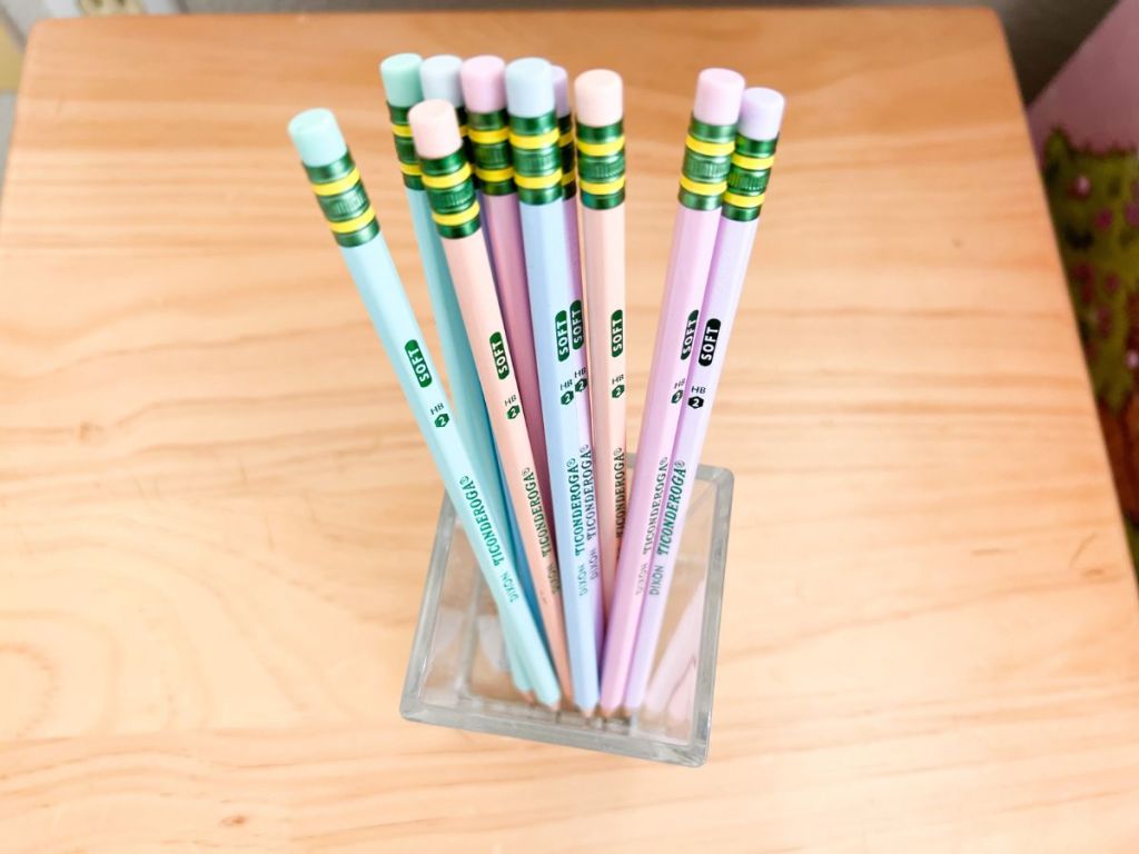 Ticonderoga Pastel Pencils in clear pencil holder on wood desk