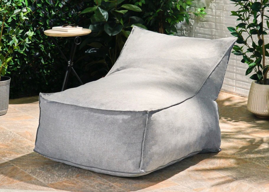 gray lounger chair sitting on outdoor patio