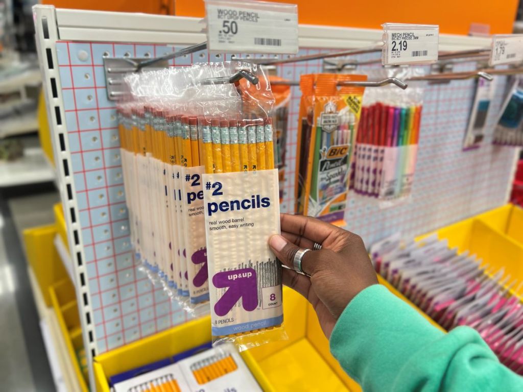 Hand holding a package of Up & Up pencils
