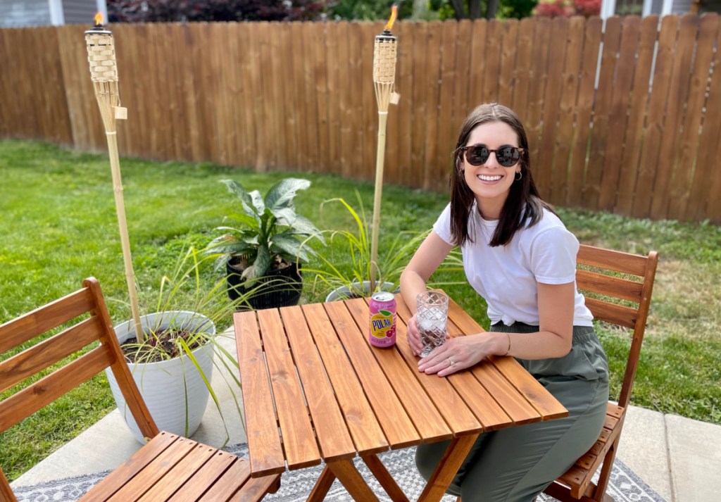 Woman sitting at her new patio table from Walmart