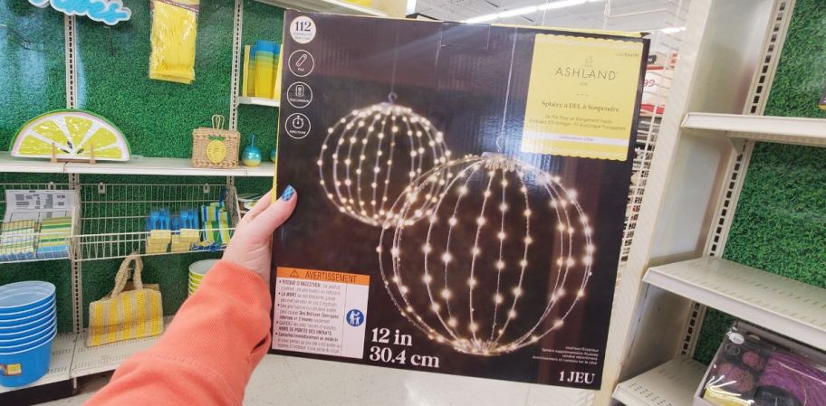 womans hand displaying an led ligthed orb box
