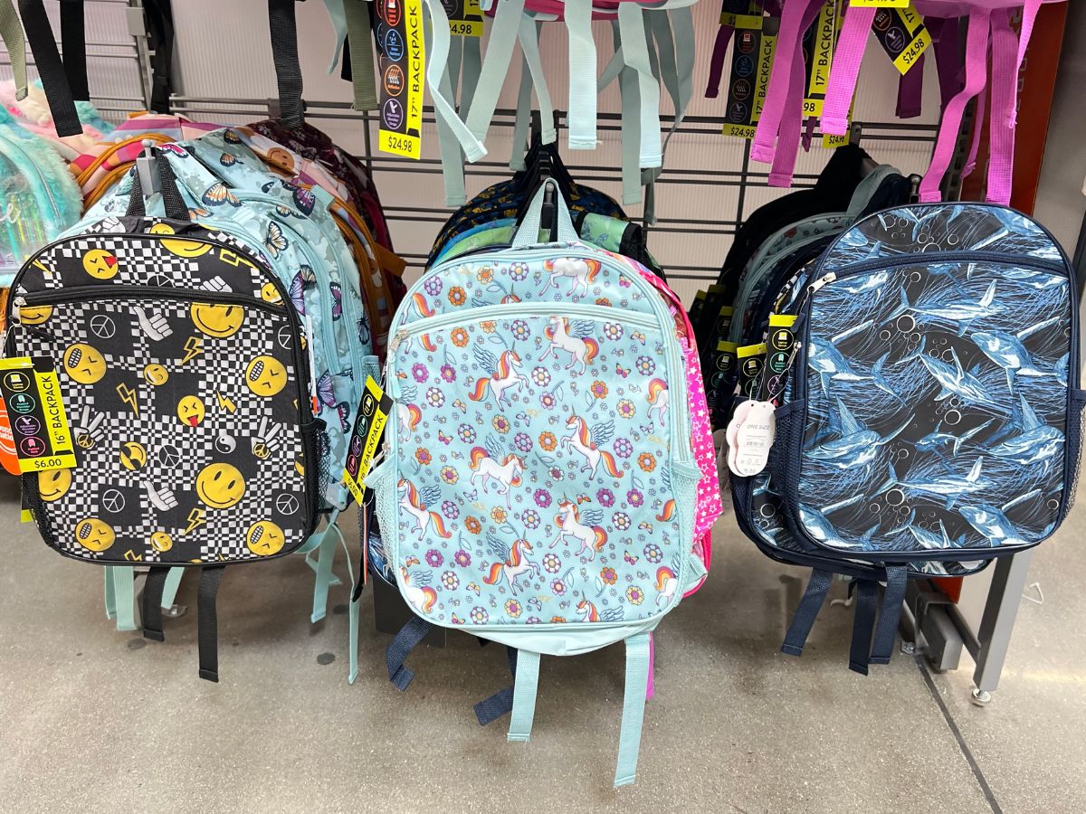 many kids backpacks hanging in store