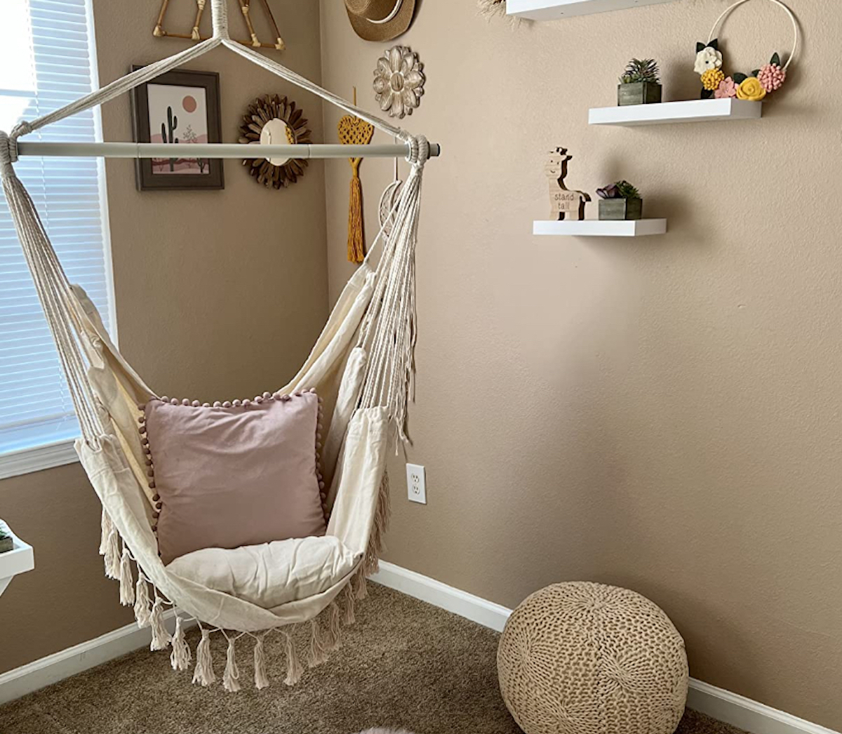 room with hanging seat with pink pillow
