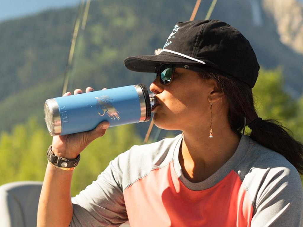 woman drinking from blue personalized yeti water bottle