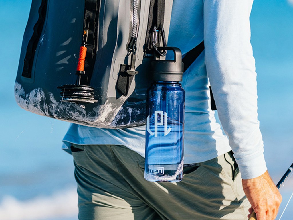 blue personalized water bottle hanging from a backpack