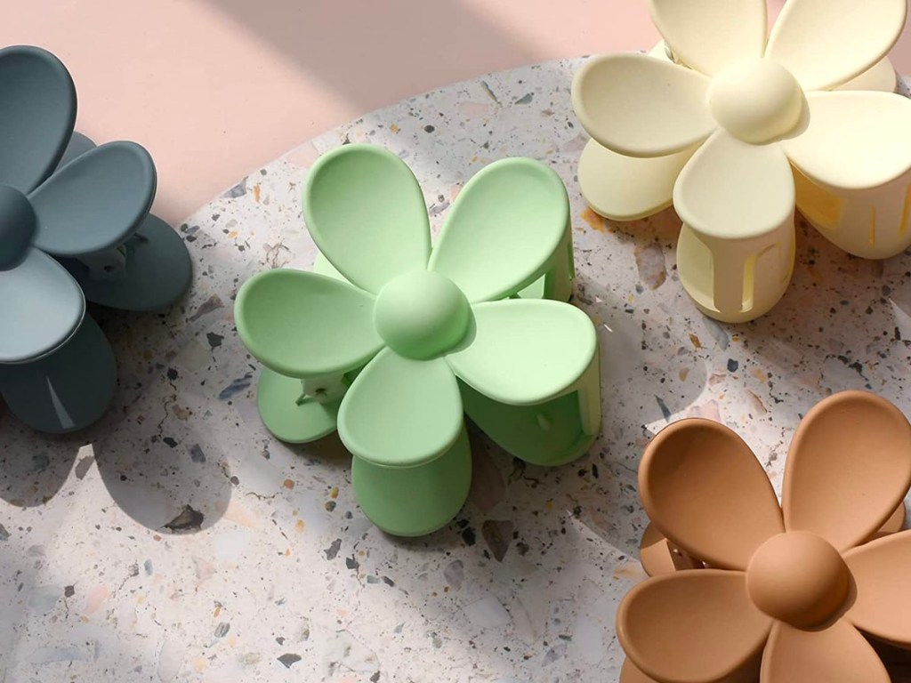 blue, green, white and brown flower hair clips on counter 