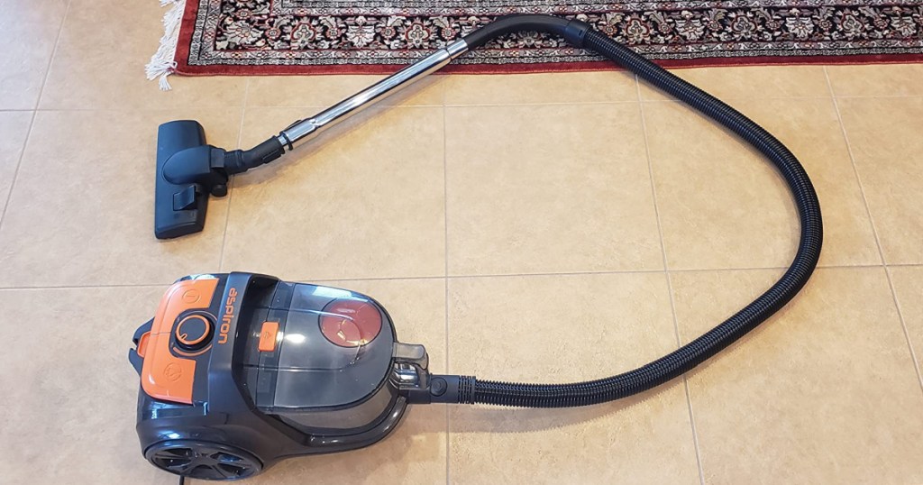 canister vacuum cleaner on floor