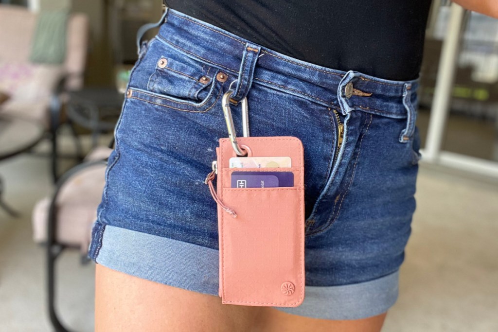 peach slim wallet clipped to jean shorts