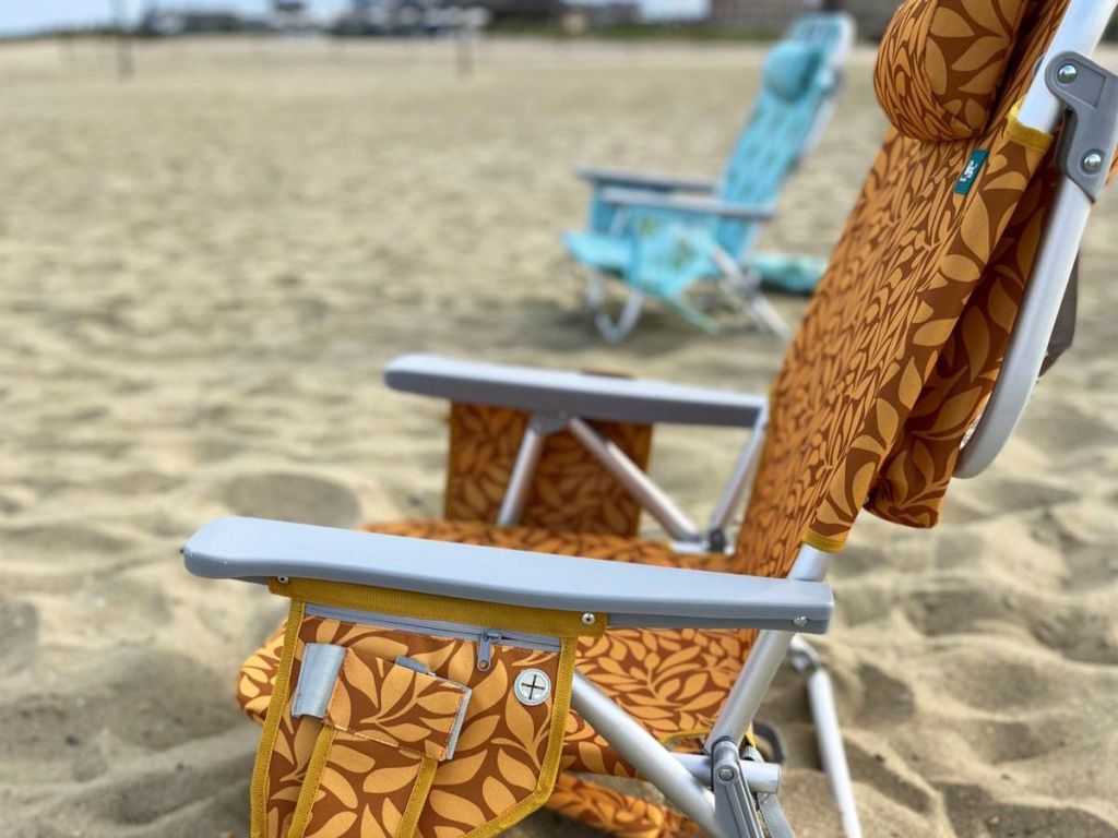 orange and brown leaf patterned beach chair on beach