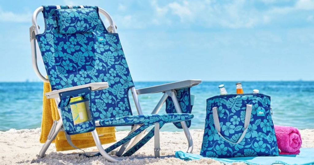 blue floral patterned beach chair and matching cooler bag on beach