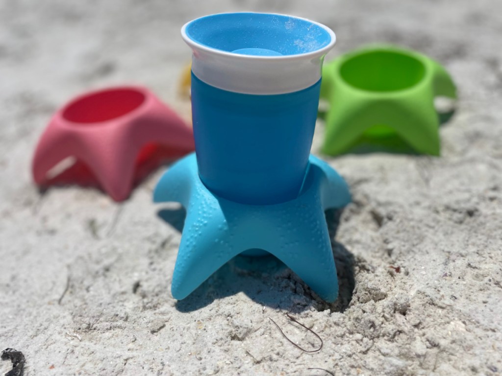 blue cup sitting in a starfish shaped holder as a beach hack