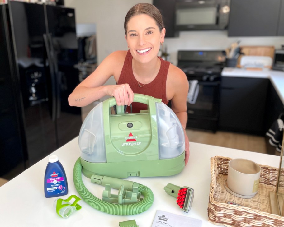 woman next to small carpet cleaner