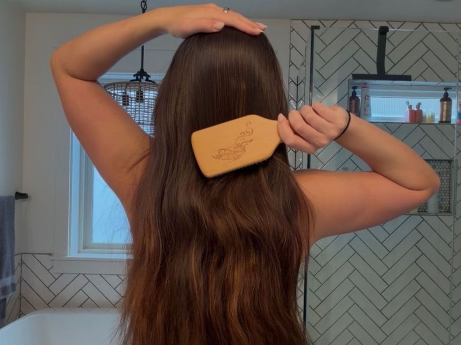girl using Boar Bristle Hair Brush to brush her hair