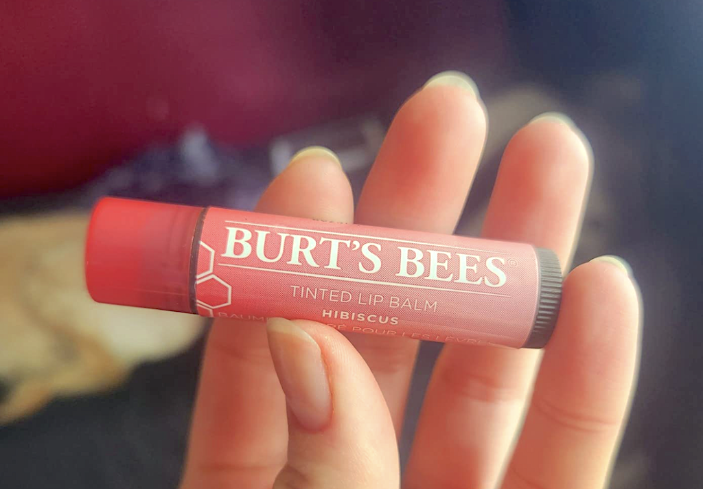 holding Burt's Bees tinted lip balm