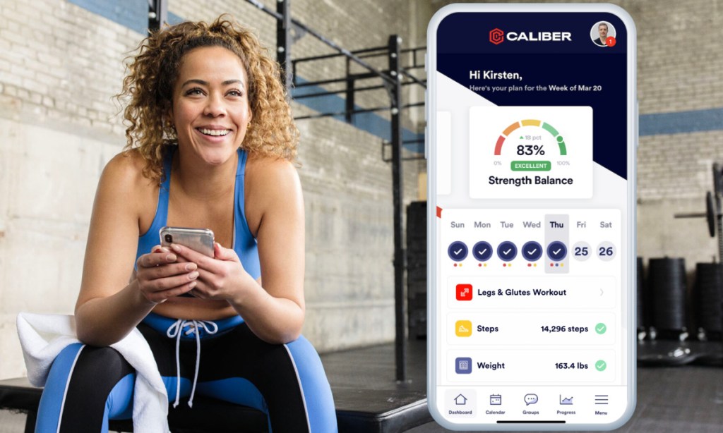 woman working out next to app on phone