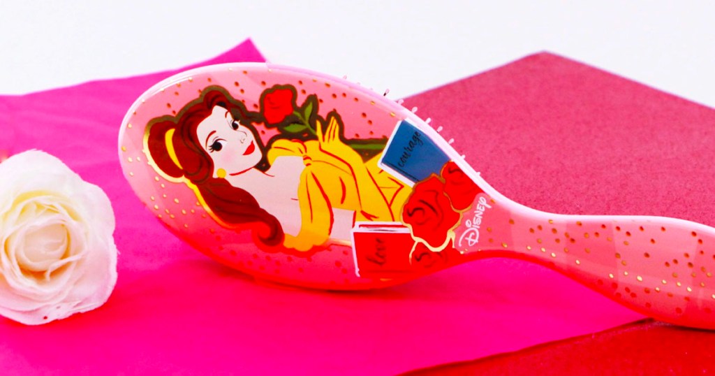 disney belle wet brush laying on pink table