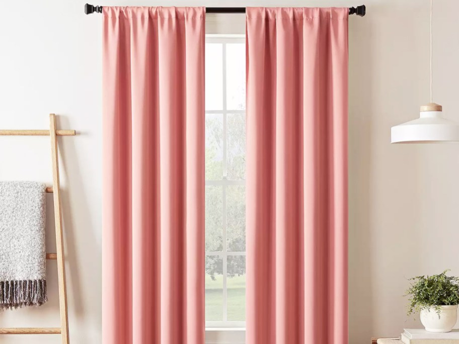 pink blackout curtains over window