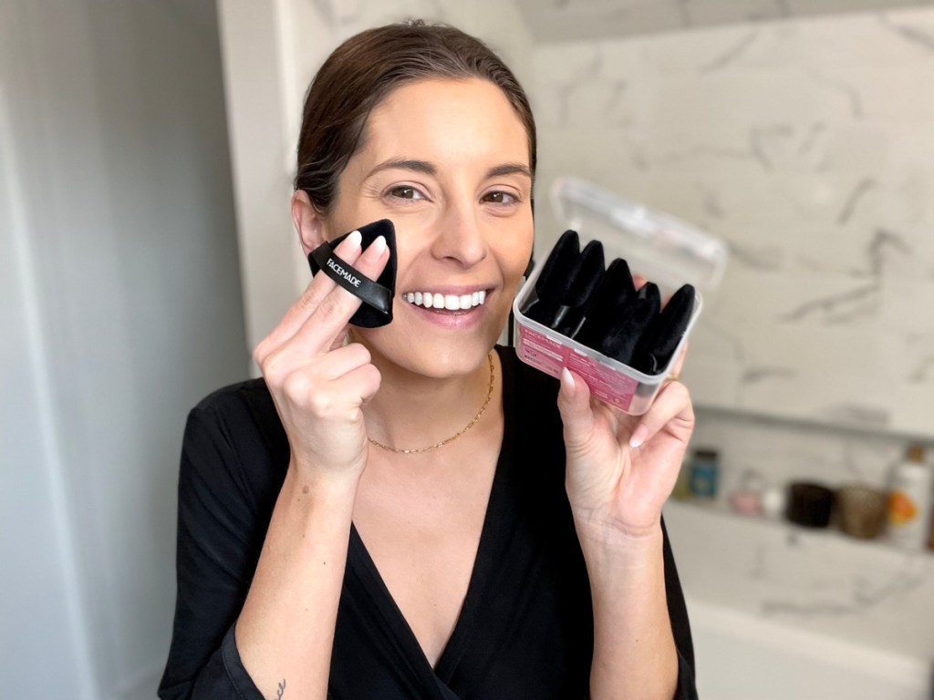 woman holding up facemade makeup puffs