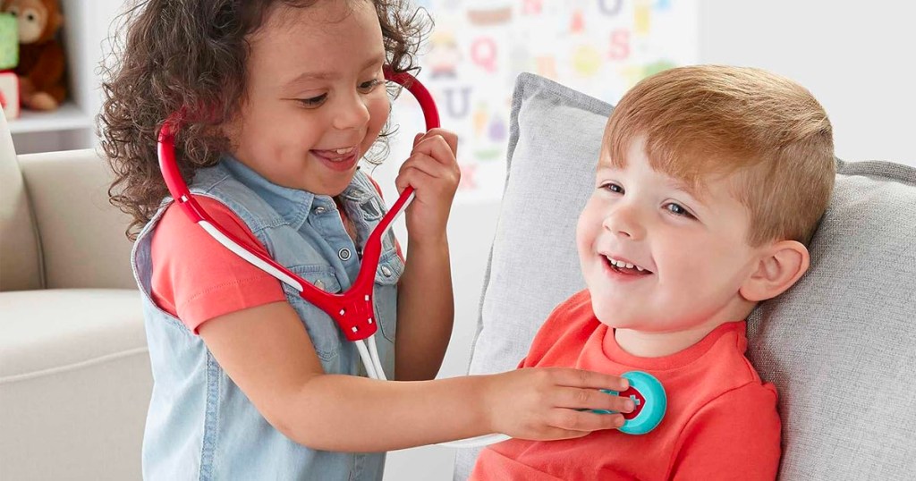 two kids playing with play stethoscope