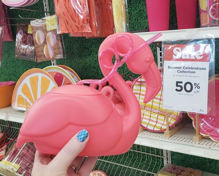 womans hand displaying flamingo tumbler with straw 