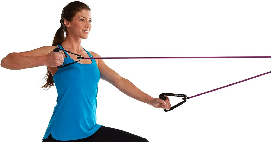 woman in blue shirt using resistance band