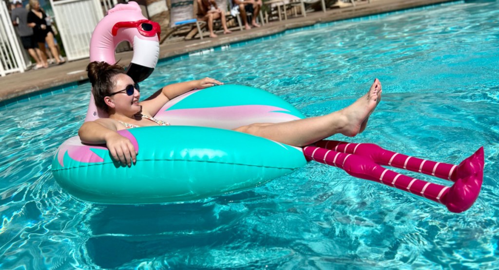 girl floating in flamingo float at the pool